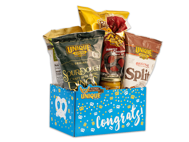 Congrats basket box, blue background with gold and white dots, pretzels on box filled with various Unique Snacks products