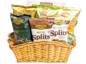Curved rectangle light brown woven basket filled with various Unique Snacks products