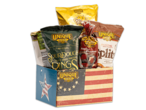 Colonial flag basket box with the original American flag on it, filled with various Unique Snacks products