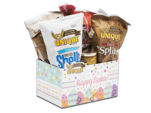 Easter basket box, white with pastel dots, decorated eggs and text, "Happy Easter" on box filled with various Unique Snacks products