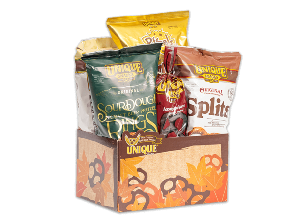 Fall basket box, brown pretzels and fall color leaves on box filled with various Unique Snacks products
