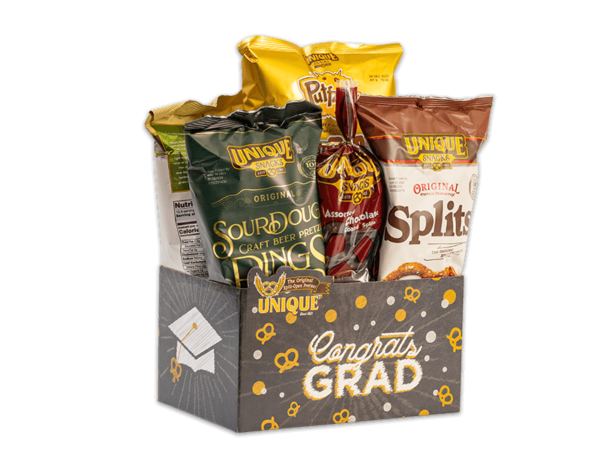 Congrats grad gray basket box, gray background with graduation cap, dots and pretzels, text "Congrats Grad" on box filled with various Unique Snacks products