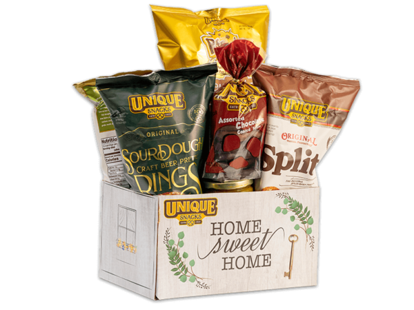 Unique snacks bundle box thats white with greenery surrounding the words home sweet home on it, it contains sourdough rings, honey mustard dip, original splits and others
