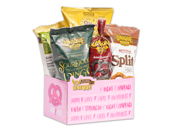 Breast Cancer awareness basket box, pink sides with pink ribbon in the shape of a pretzel filled with various Unique Snacks products