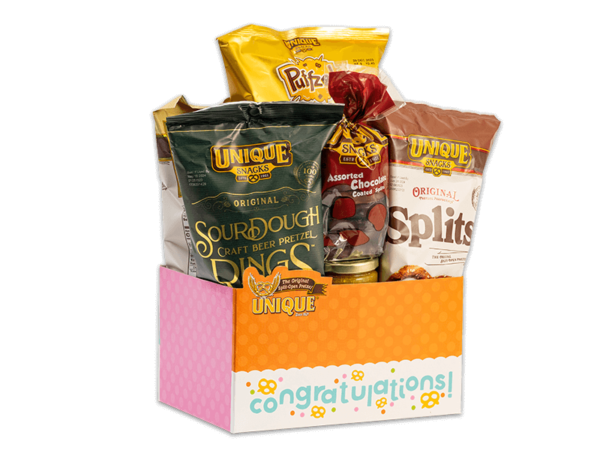 Congratulations basket box, orange, pink, and white sides and polka dots with text "Congratulation" on box filled with various Unique Snacks products