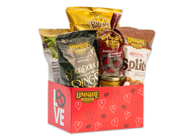 Unique snacks bundle box thats red with white and black hearts all over it, it contains sourdough rings, honey mustard dip, original splits and others