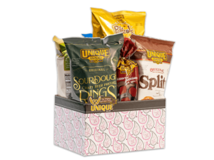 Pink and paisley basket box filled with various Unique Snacks products