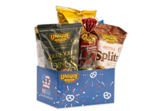 Patriotic pretzel basket that has pretzel fireworks in red white and blue on it, filled with various Unique Snacks products