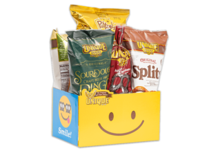 Smiley face basket box filled with various Unique Snacks products