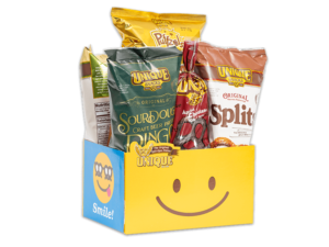 Smiley face basket box filled with various Unique Snacks products