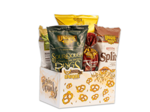 Give thanks basket box, white background with golden pretzel and wheat, text, "give thanks" on box filled with various Unique Snacks products