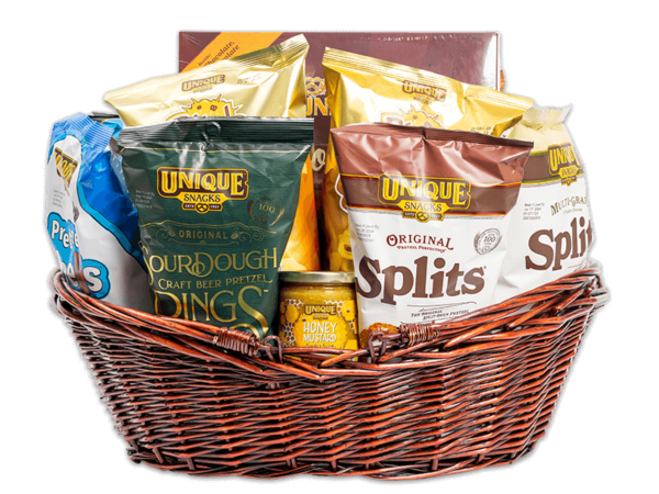Large, woven, dark brown basket filled with various Unique Snacks products