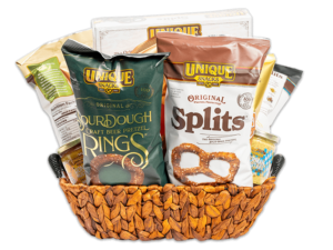 varied unique snacks products in a medium wash woven basket