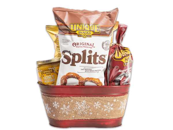 Red metal basket with a brown burlap ribbon that had white snowflakes on it rapped around the basket filled with various Unique Snacks products