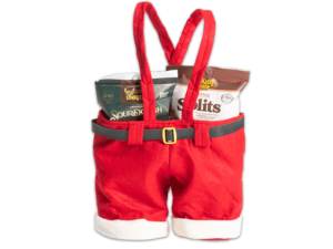 Santa pants basket suspenders that are red and white and have a black and gold belt on it, filled with various Unique Snacks products