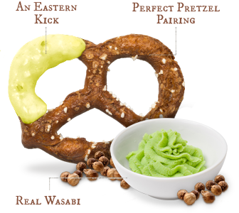 Pretzel with green wasabi I dip on it and green wasabi in small white bowl to the side of pretzel