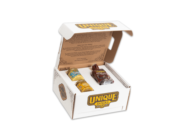 Chocolate Bag and Dips Topper box filled with 2 dips and coated pretzels in a white box with the unique snacks logo on it