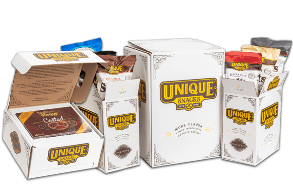 Unique snacks variety packaging in white boxes with unique snacks logo