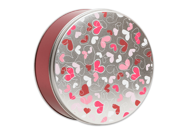 Fluttering hearts 24 count pink tin with a silver lid that has pink, red, and white hearts all over the lid